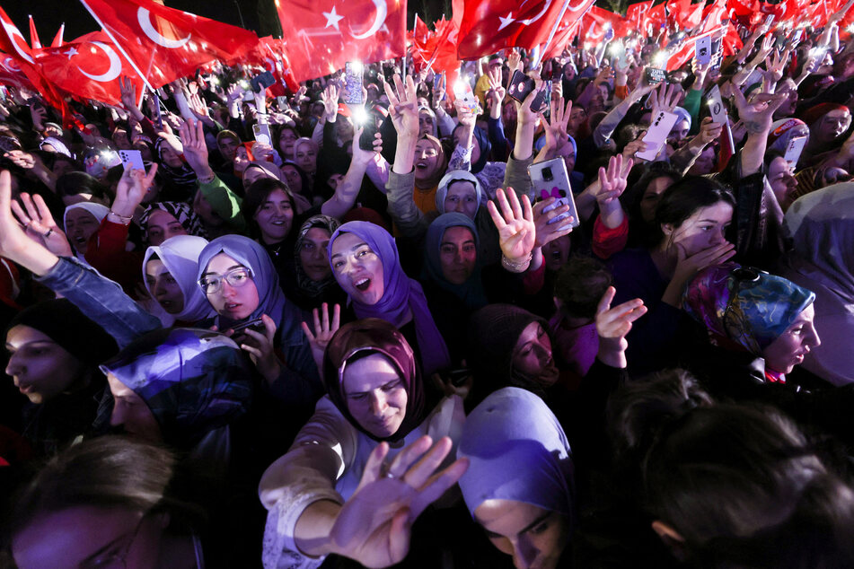 Supporters of Turkish President Tayyip Erdogan celebrate following his electoral victory.