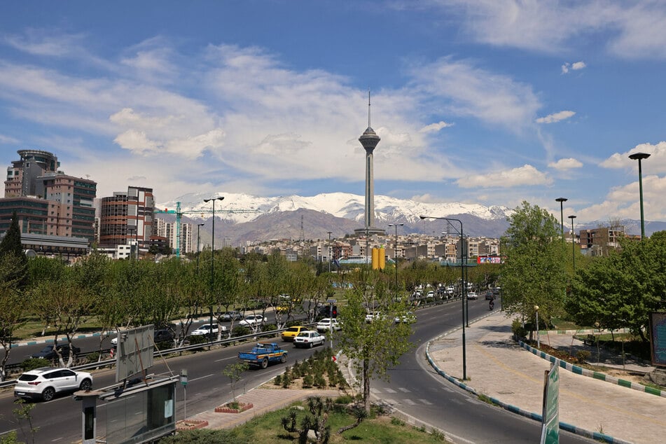 Motorists drive along a busy street past the Milad Tower (C) in Tehran on Saturday.