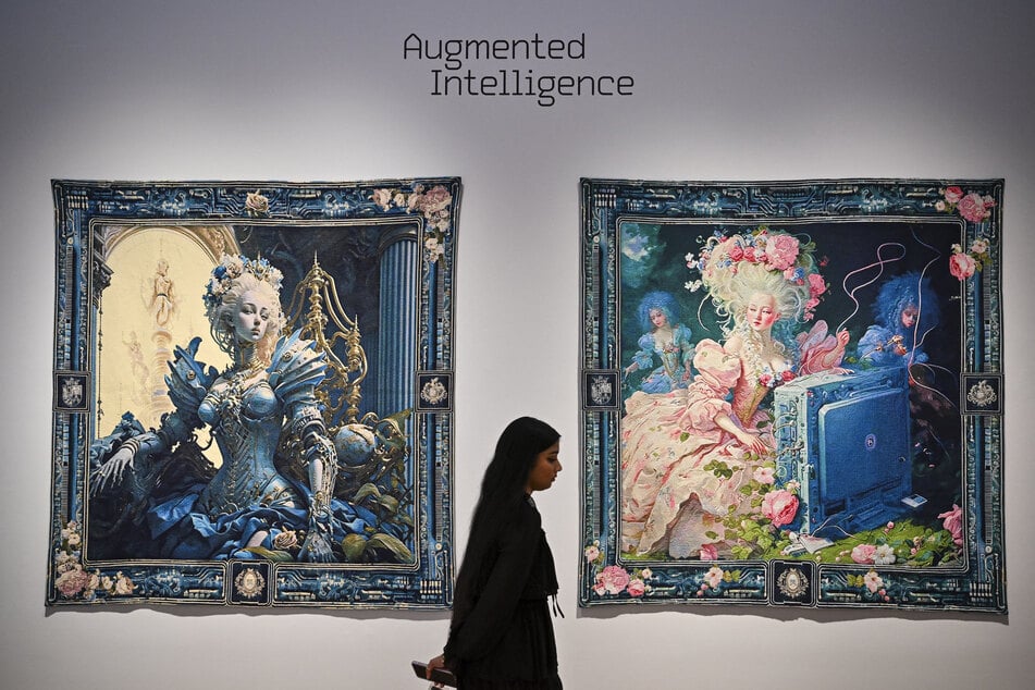 A person walks past AI artwork created by Grimes, Mac Boucher, Mary Jacobo and Eurypheus called "Marie Antoinette After the Singularity #1 and Marie Antoinette After the Singularity #2" at a press preview for Augmented Intelligence at Christie’s on February 20, 2025 in New York City.