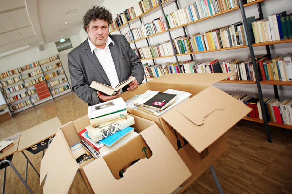 Jürgen Küfner (51), Direktor der Volkshochschule Dresden, zeigt einige der 13.000 geschenkten Bücher.