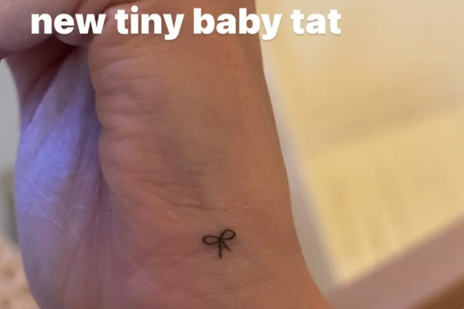Hailey Bieber's latest tattoo features a small, delicate bow on her wrist.