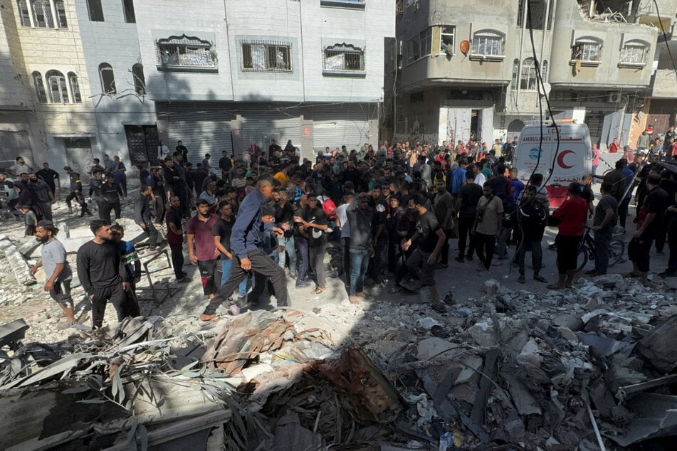 The Gaza civil defense agency said Israel struck a school building sheltering displaced Palestinians on Sunday, killing at least nine people.