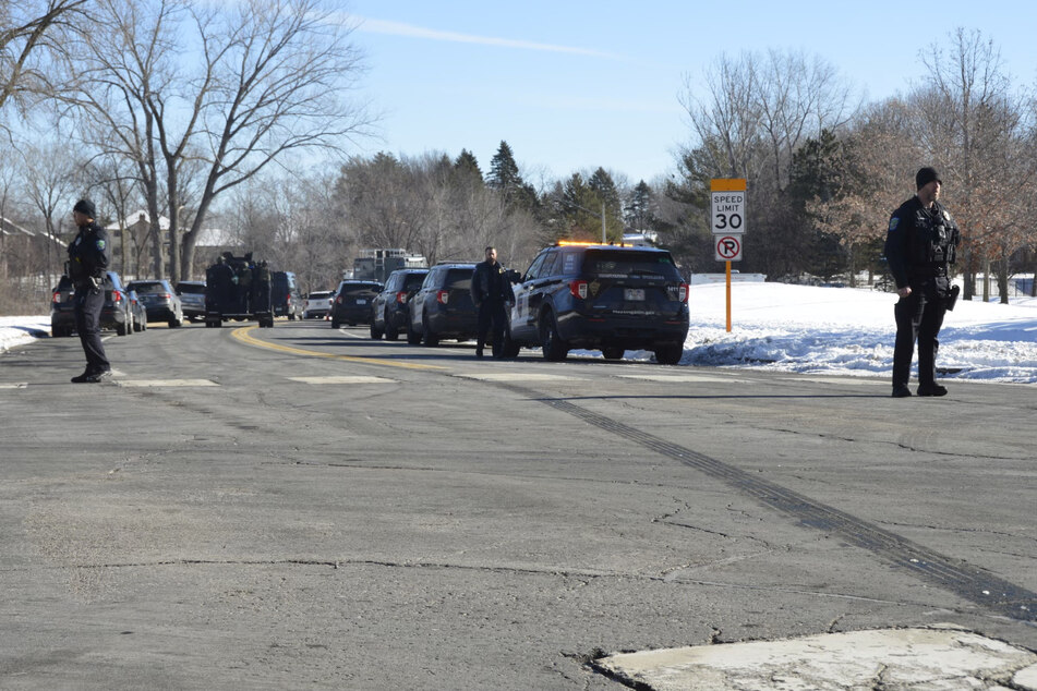 Law enforcement officers stand guard near the scene of an incident in which police officers were killed while responding to an emergency call in Burnsville, Minnesota.
