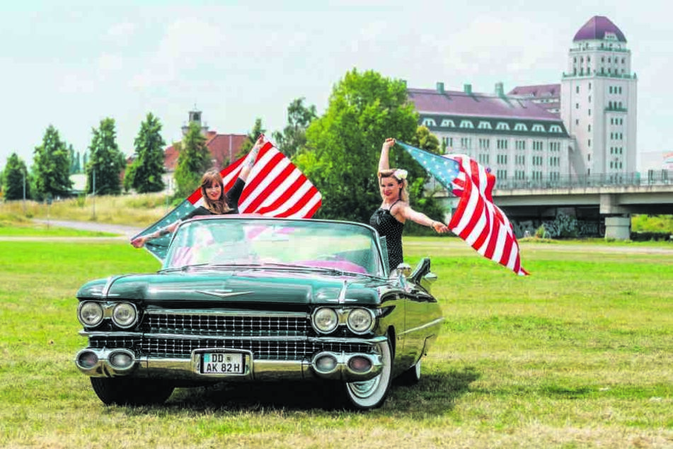Drei Mädels: Sarah 28, (l.) und Katja (28) schwenken in Cadillac-Lady "Christine" die amerikanische Flagge.