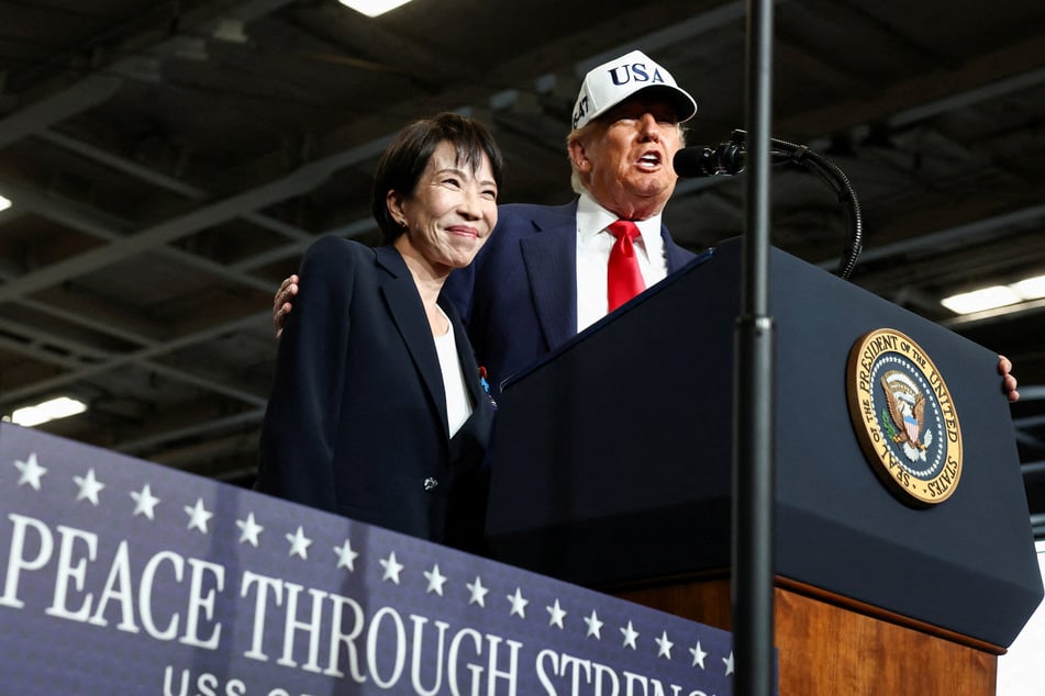 Japanese Prime Minister Sanae Takaichi (l.) stands alongside US President Donald Trump aboard the aircraft carrier USS George Washington, during a visit to US Navy's Yokosuka base in Yokosuka, Japan, on October 28, 2025.