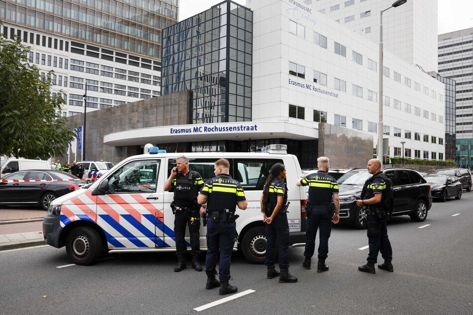 Polizeibeamte stehen vor dem Erasmus-Krankenhaus. Die Beamten suchen aktuell noch nach dem Täter.