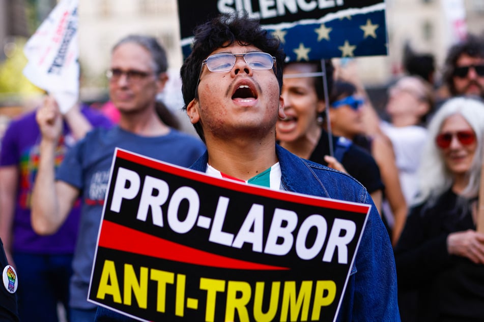 A protester holds a "Pro-Labor, Anti-Trump" sign as people demonstrate during a Labor Day "Workers Over Billionaires" rally outside Trump Tower in New York City on September 1, 2025.
