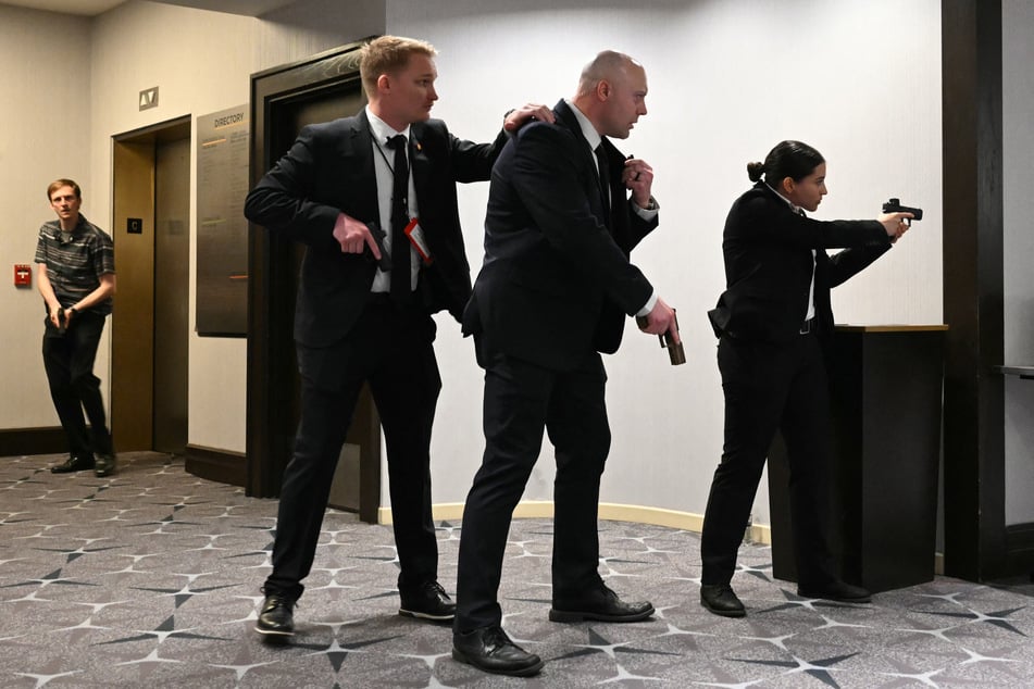 Agents drew their guns after loud bangs were heard during the White House Correspondents' dinner at the Washington Hilton in Washington, DC, on April 25, 2026.