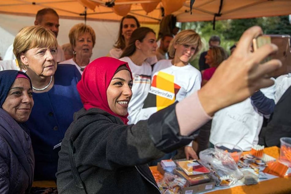 Die aus Damaskus geflohene Ghalia Badr fotografiert in Stralsund (Mecklenburg-Vorpommern) beim Bürgerfest der CDU ein Selfie mit Angela Merkel (CDU).