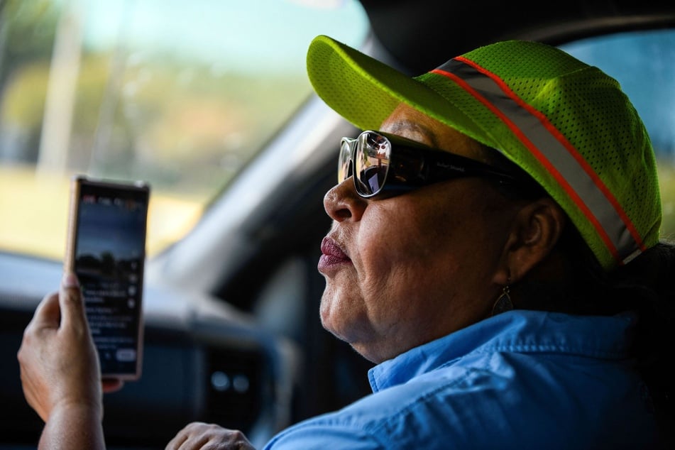 Martina Grifaldo of Alianza Latina Internacional broadcasts live via social media while tracking ICE operations in Houston, Texas, on September 17, 2025.
