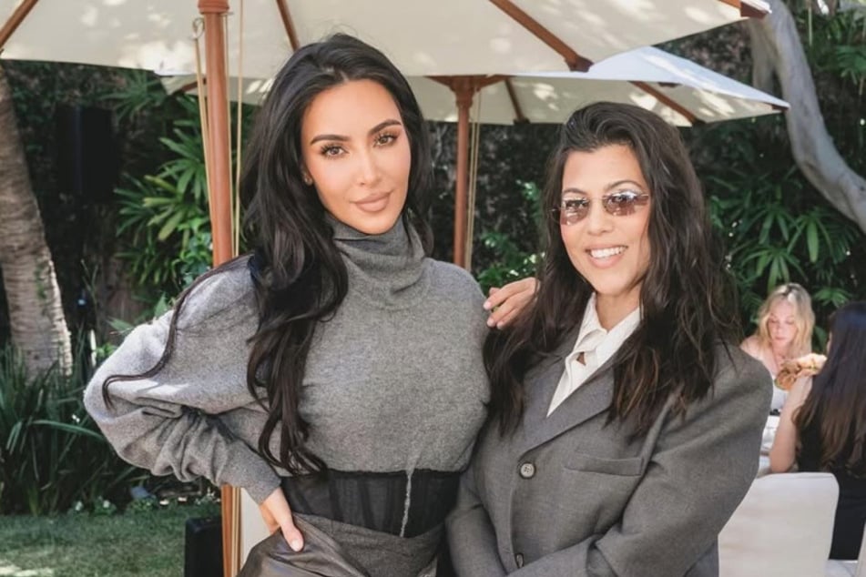 Kourtney Kardashian (r) made sister Kim Kardashian's (l) surprise graduation party awkward.