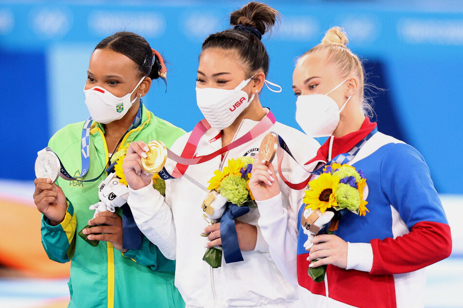 Athletes Rebecca Andrade of Brazil, Sunisa Lee of the US, and Angelina Melnikova of the ROC (l. to r.) pose with their silver, gold, and bronze medals respectively won in the women's artistic gymnastics individual all-around event at the Ariake Gymnastics Centre on Thursday.