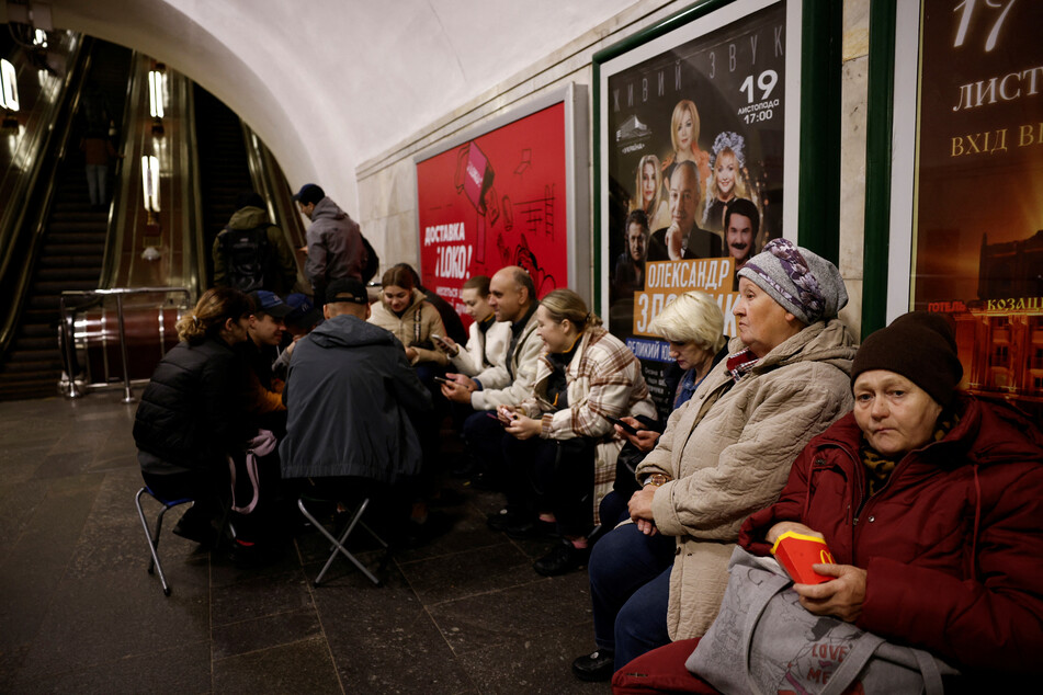 Kyiv residents sheltered in the city's subway as air sirens rang out after Russia's assault.