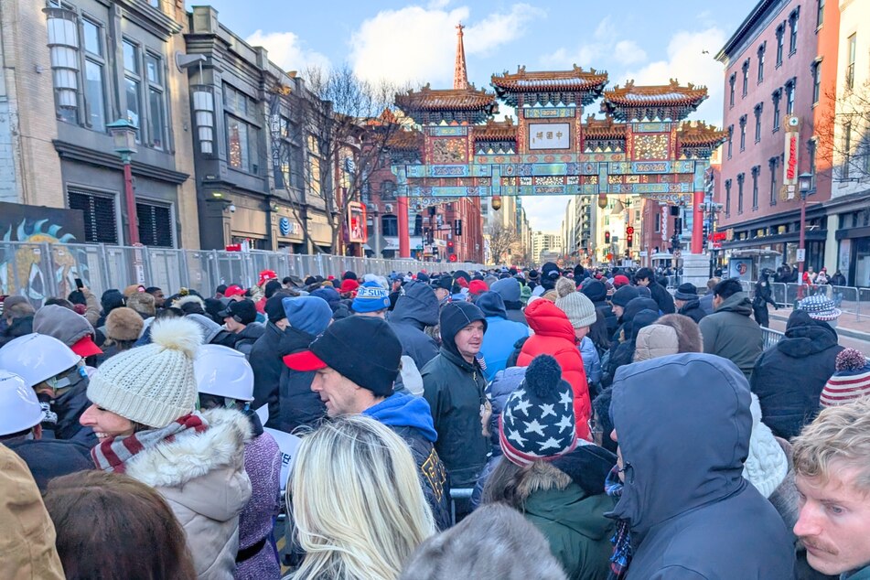 MAGA fans arrive in Chinatown to wait in line for a streaming of Donald Trump's inauguration at the Capital One Arena on January 20, 2025.