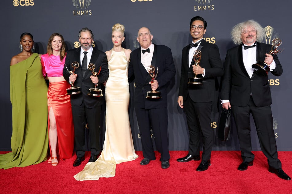 The Queen's Gambit took home the Outstanding Limited Or Anthology Series award during the 73rd Primetime Emmy Awards last year. (From l to r) Moses Ingram, Marielle Heller, Scott Frank, Anya Taylor-Joy, William Horberg, Mick Aniceto, and Marcus Loges posed with the award on the red carpet.