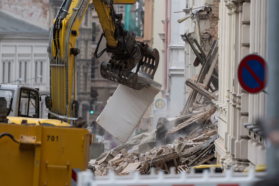 Einsatzkräfte arbeiten mit schweren Gerät an der Einsatzstelle.