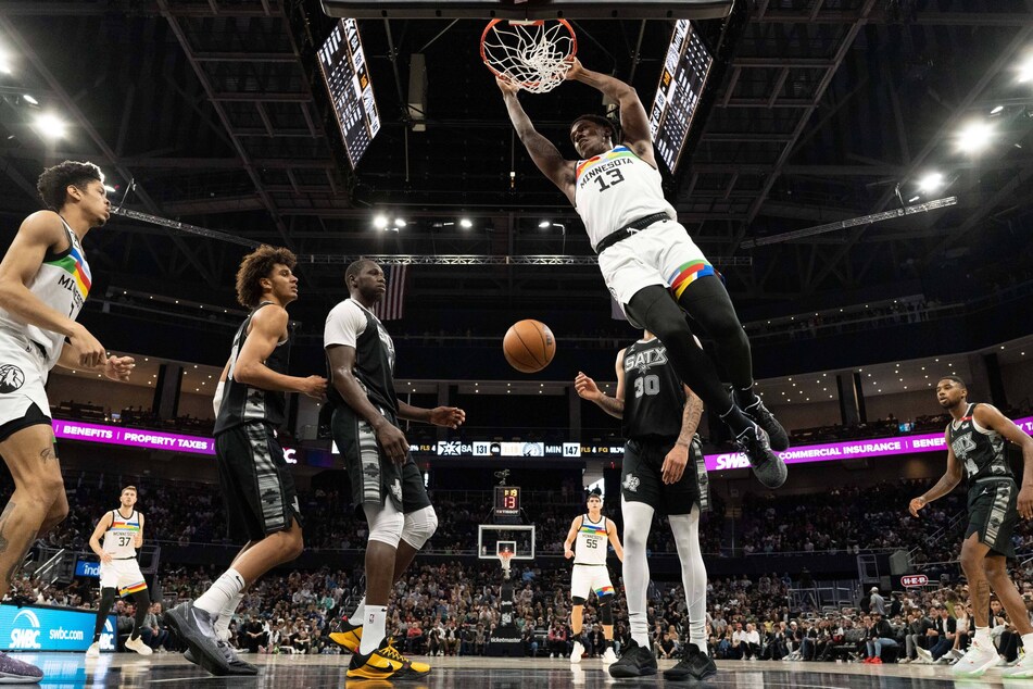 Minnesota Timberwolves forward Nathan Knight (c) dunks over San Antonio Spurs players during their blowout win at the Moody Center in Austin, Texas.