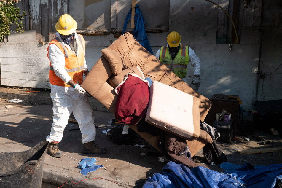 Homelessness rates are high in Los Angeles: this picture shows sanitation workers clearing out a homeless encampment in the city in August 2020.