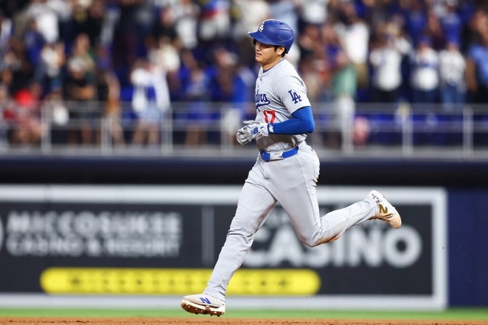 Shohei Ohtani of the Los Angeles Dodgers runs the bases after hitting a two-run home run, his 50th of the season.