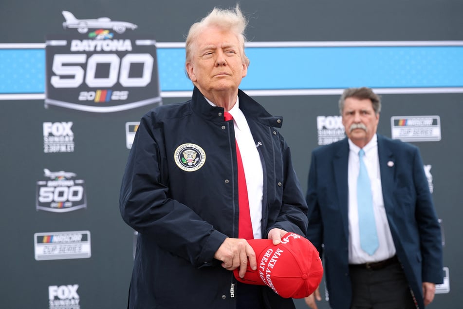 President Donald Trump stands during the national anthem prior to the NASCAR Cup Series Daytona 500 at Daytona International Speedway on February 16, 2025.