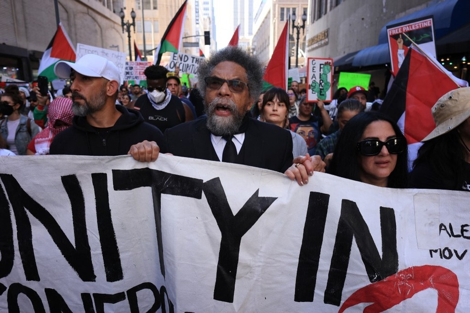 Independent presidential candidate Dr. Cornel West holds a banner as he joins a march in Los Angeles, California, in solidarity with the Palestinian people under Israeli attack.