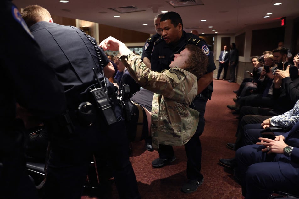 Greg Stoker is removed by US Capitol Police after demonstrating during the Senate Armed Services confirmation hearing for Defense Secretary nominee Pete Hegseth on January 14, 2025.