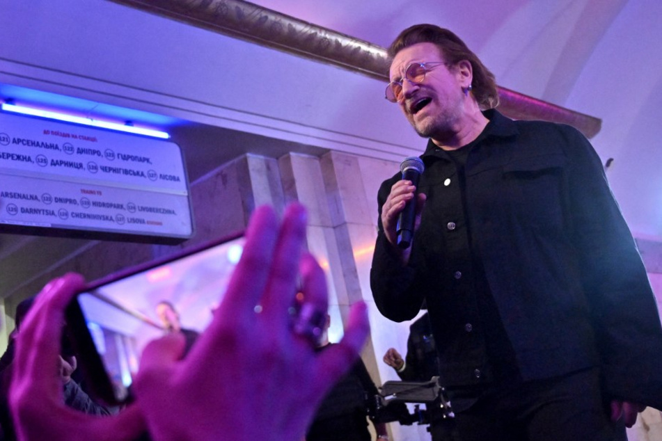 U2's Bono and the Edge perform in Ukraine subway station for peace