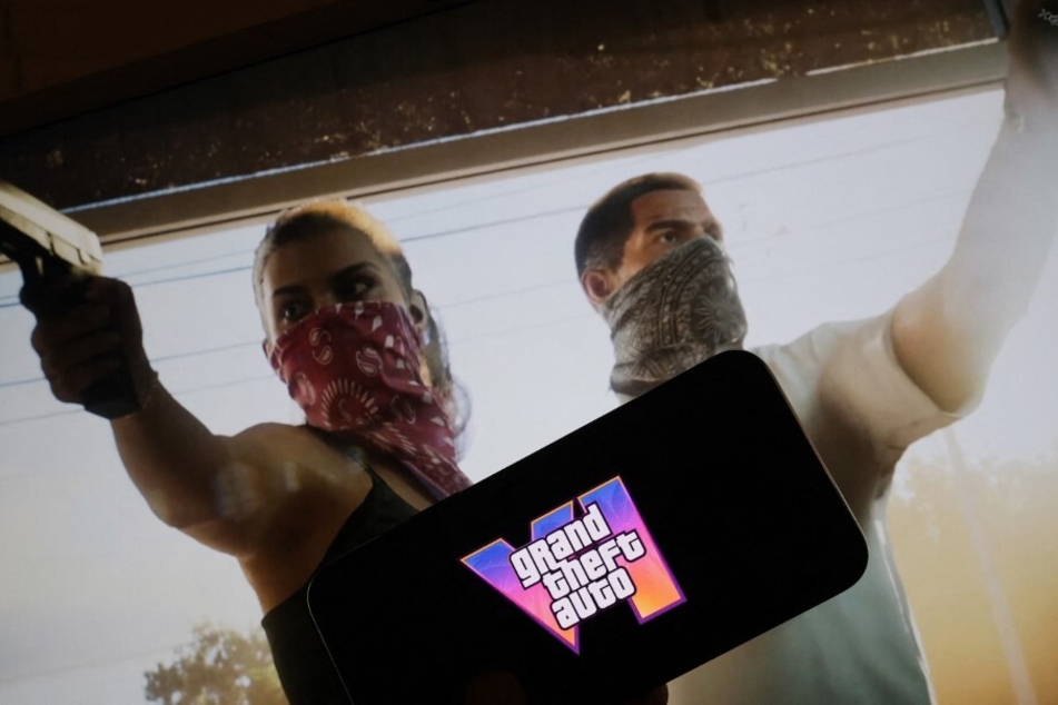 The Grand Theft Auto VI trailer shows a female character named Lucia and her male partner wielding guns with bandanas covering their faces.
