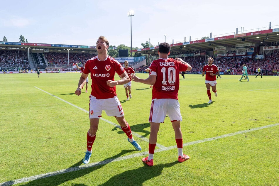 Moritz Hannemann (l.) und Tolcay Cigerci bejubeln das 3:1 - da war das Flutlicht (im Hintergrund) wieder an.