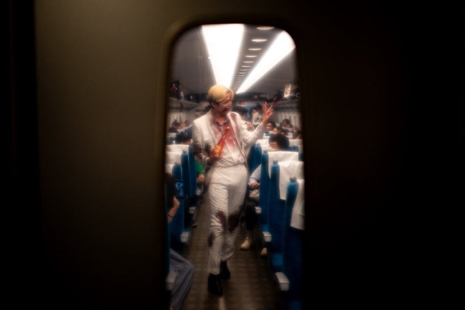 An actor performs for passengers during the 'Zombie Shinkansen' event on a bullet train from Tokyo to Osaka.