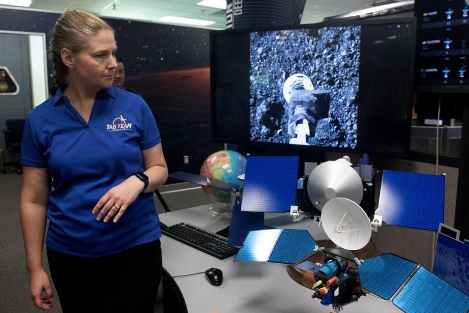 Sandy Freund, Lockheed Martin OSIRIS-REx program manager, looks over a display during a media tour of NASA's first major asteroid sample recovery rehearsal.