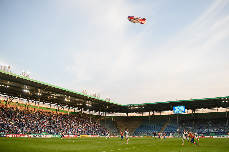 Ein Zeppelin fliegt während eines Fußball-Spiels über die Magdeburger MDCC-Arena.
