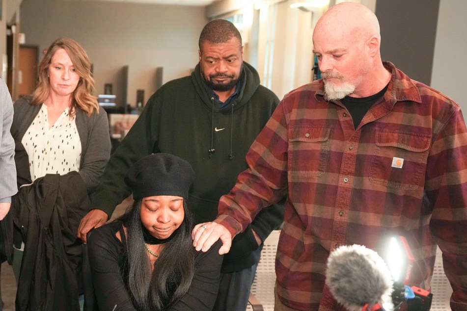 Friends and family of Garrett Foster, comforting his fiancée Whitney Mitchell (bottom l.), after Daniel Perry was convicted of murdering Foster in Austin, Texas on Friday April 7, 2023.