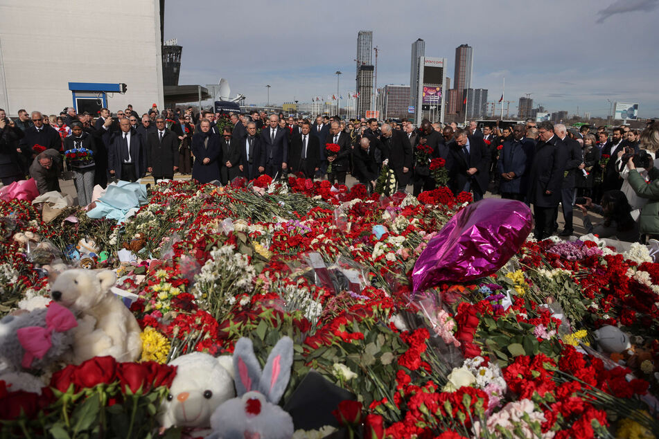 Ambassadors and representatives of diplomatic missions accredited in Russia stand at attention as they attend a flower laying ceremony at the memorial in memory of the victims of the terrorist attack at the Crocus City Hall concert venue a week after the attack in Krasnogorsk, outside Moscow on Saturday.