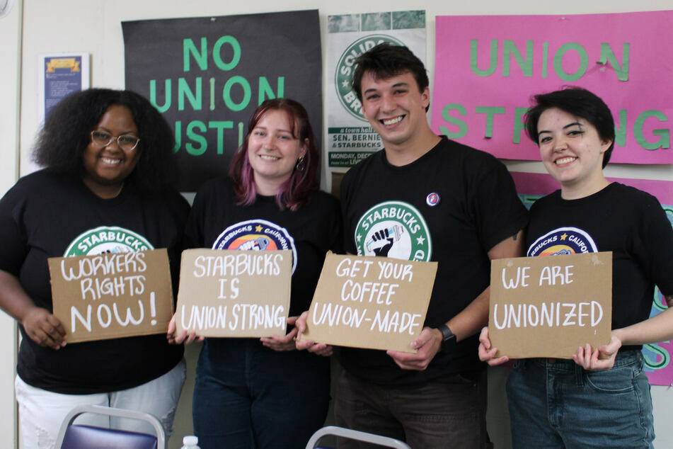 Joe Thompson (second from r.) and fellow Starbucks workers in Santa Cruz celebrate their union election victories.