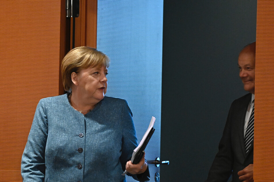 Bundeskanzlerin Angela Merkel (l, CDU) kommt neben Olaf Scholz (SPD), Bundesfinanzminister, zur Sitzung des Bundeskabinetts im Kanzleramt.