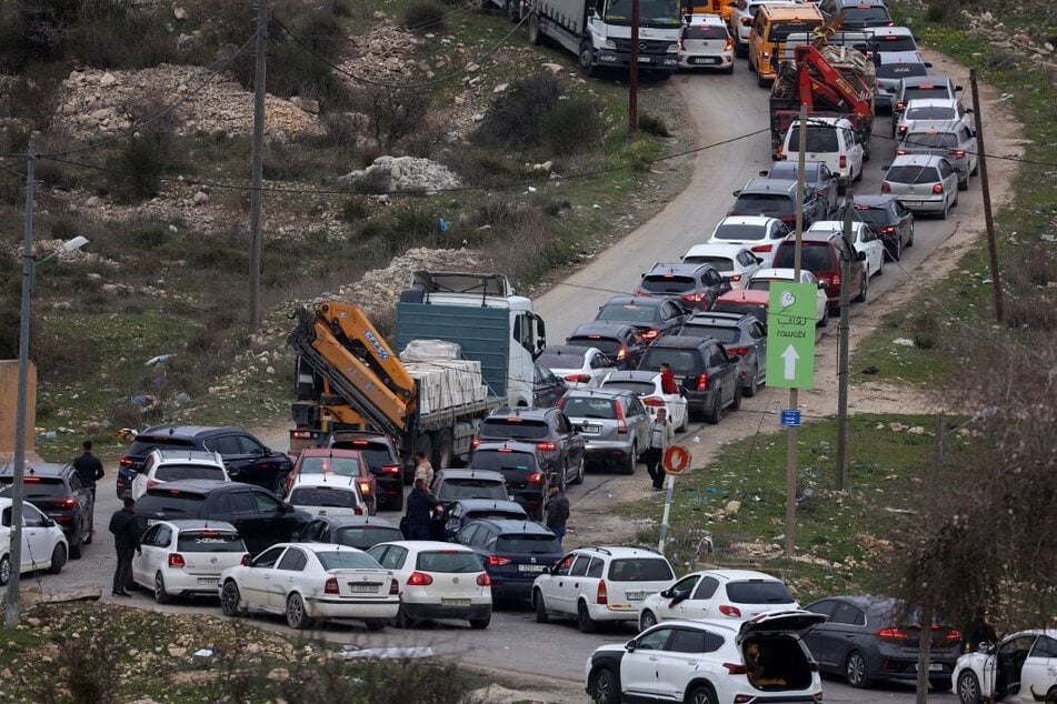 A long line of cars waits to pass through the Israeli Atara checkpoint on route 465 near Ramallah in the occupied West Bank on January 22, 2025.