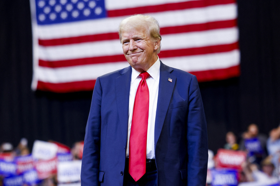 Donald Trump smiling at a crowd during a campaign rally in Bozeman, Montana on August 9, 2024.