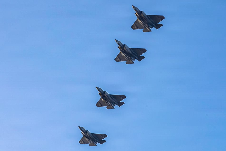 A US Navy handout photo released by CENTCOM shows F-35 Lightning II aircraft flying over the flight deck of USS Abraham Lincoln in support of the attacks on Iran.