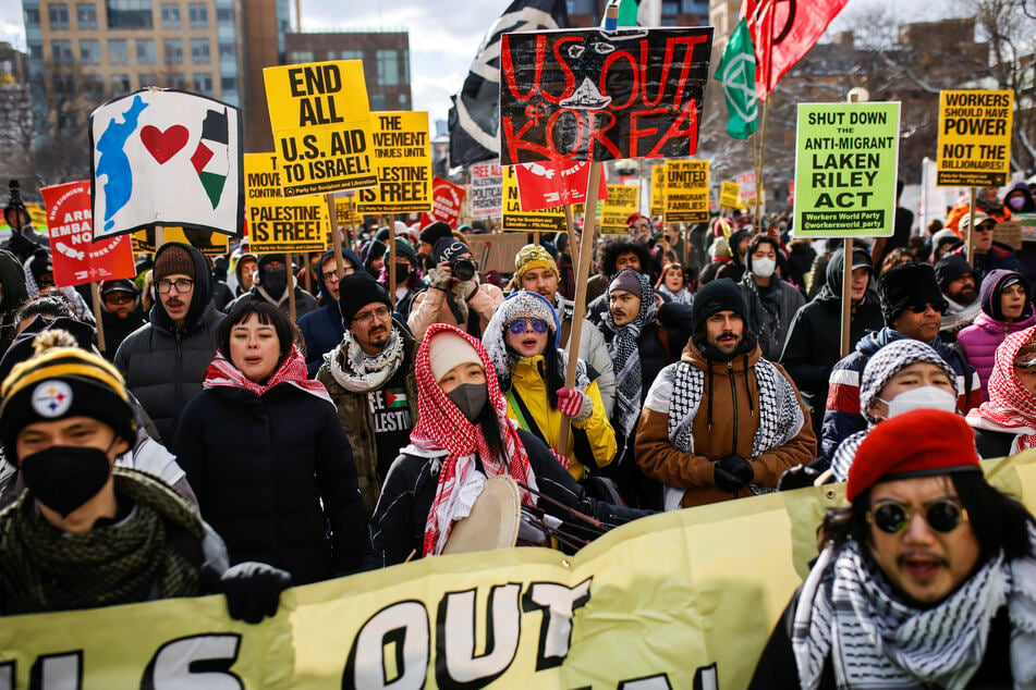 New Yorkers raise signs and march in a We Fight Back rally in opposition to Donald Trump's extreme far-right agenda on January 20, 2025.