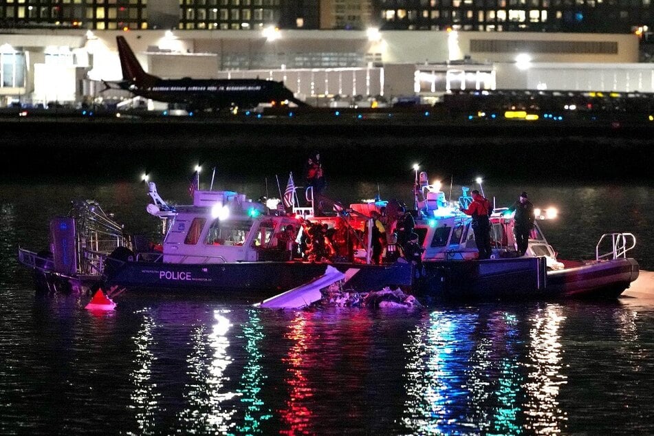 Emergency divers respond after a passenger aircraft collided with a helicopter, in the Potomac River near Ronald Reagan Washington Airport.