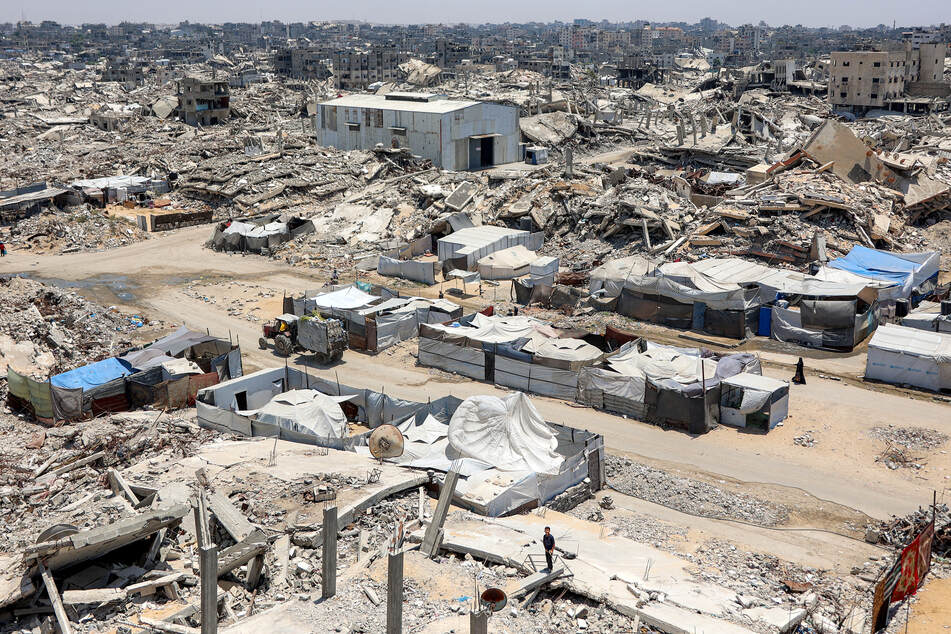 Tents and shelters are pictured next to rubble of collapsed buildings at a camp for people displaced by war in the Sheikh Radwan neighborhood of Gaza City on Monday.