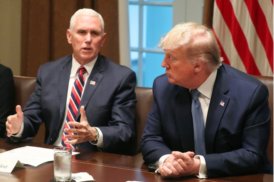 Former Vice President Mike Pence (l) speaking with then-President Donald Trump in the Cabinet Room of The White House on December 9, 2019.