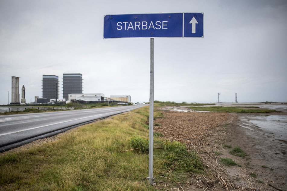 A sign pointing towards the SpaceX Starbase is pictured on the road outside Brownsville, Texas.