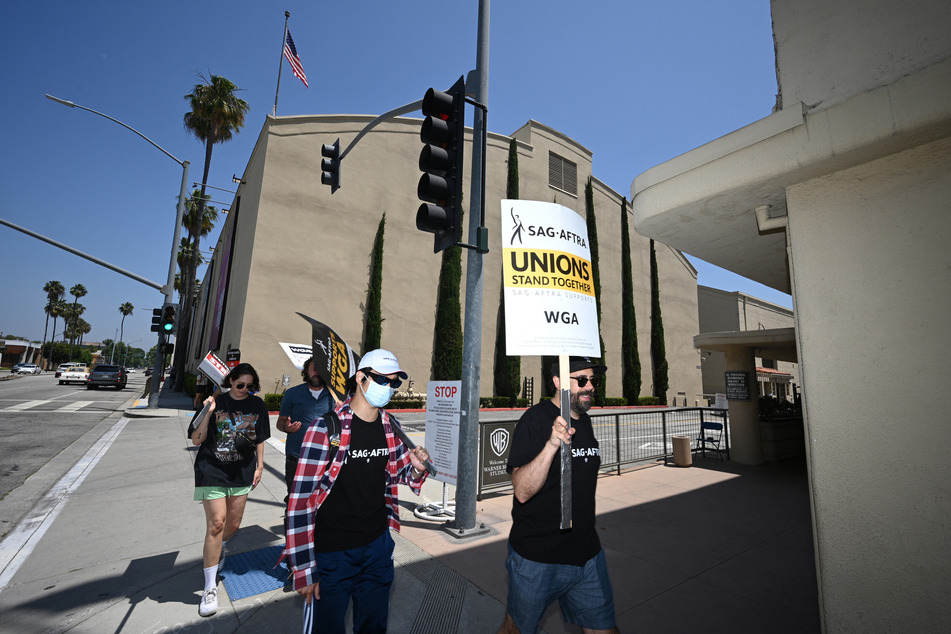 The Screen Actors Guild agreed to continue negotiations with Hollywood studios, avoiding a huge strike at least temporarily.