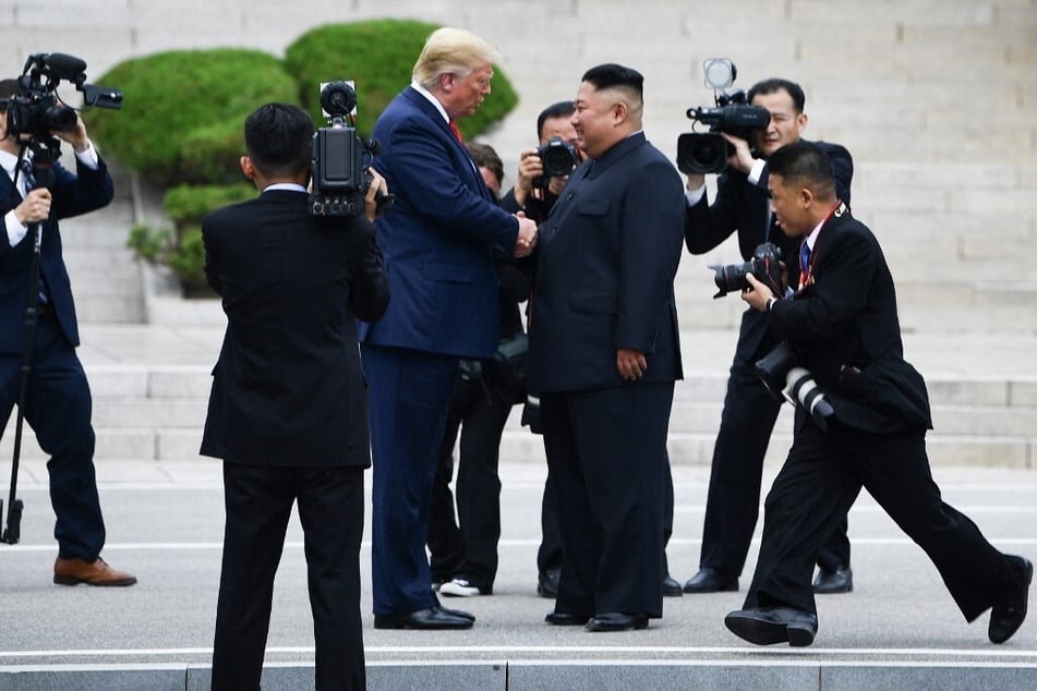 North Korea's leader Kim Jong Un shakes hands with US President Donald Trump north of the Military Demarcation Line that divides North and South Korea on June 30, 2019.