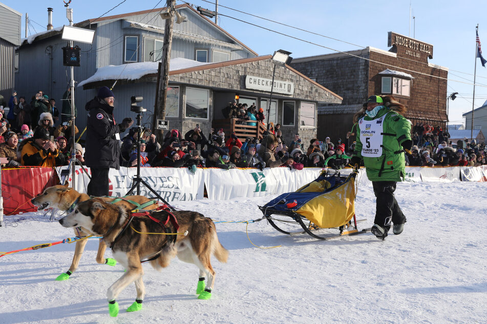 Ryan Redington, the winner of the 51st Iditarod Dog Sled race, crossing the finish line in Nome, Alaska.
