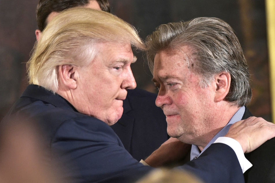 Donald Trump (l.) congratulating White House chief strategist Steve Bannon during the swearing-in of senior staff at the White House on January 22, 2017.