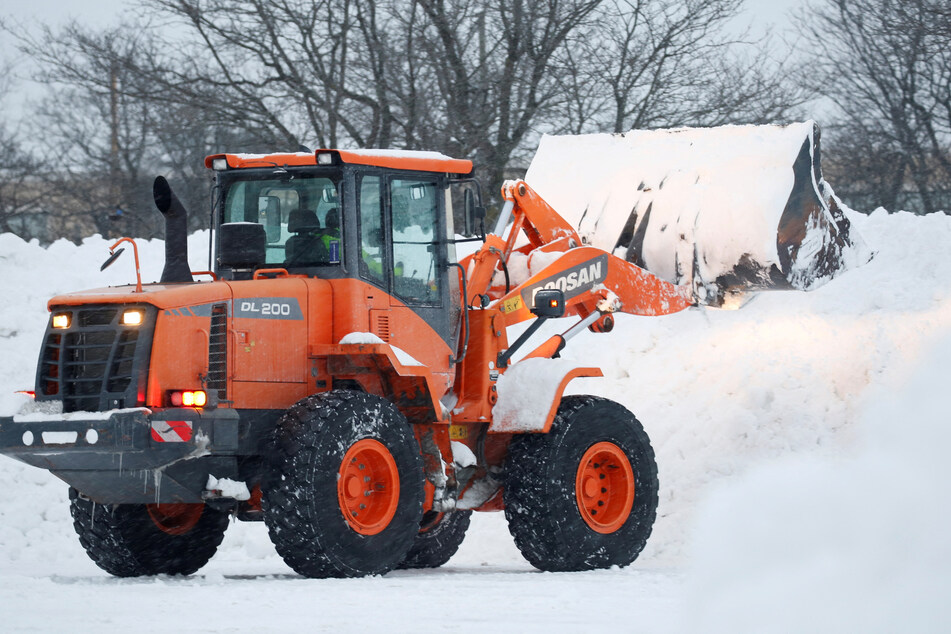 Snowplows and backhoes are helping clear the snow off the roads in New York state.