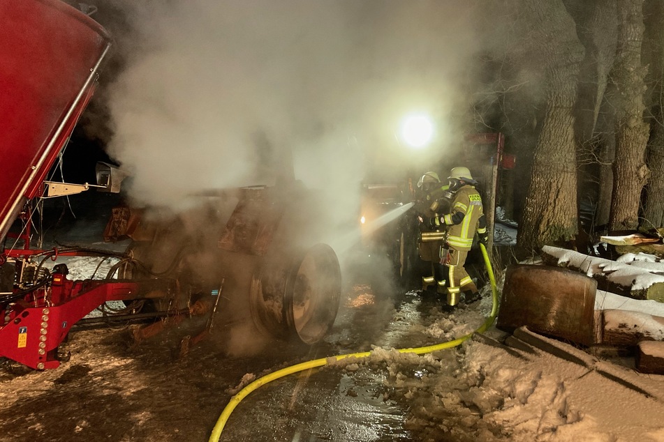 Die Einsatzkräfte der Feuerwehr Leer löschen einen brennenden Traktor.